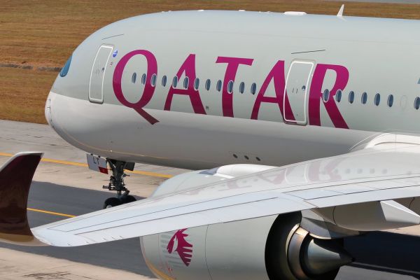 Personal de atención al cliente en check-in para volar con Qatar Airways